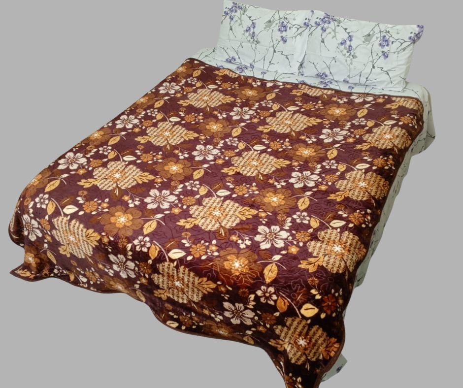 Double bed with maroon floral bedspread and white pillows with purple flower print