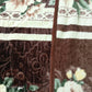 Brown and cream floral patterned fleece blanket with stitched edge and textured designs