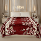 Luxurious red floral blanket on a modern bed with 'Elore' sign in stylish bedroom