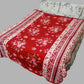 Red floral printed bed blanket on double bed with white floral pillows